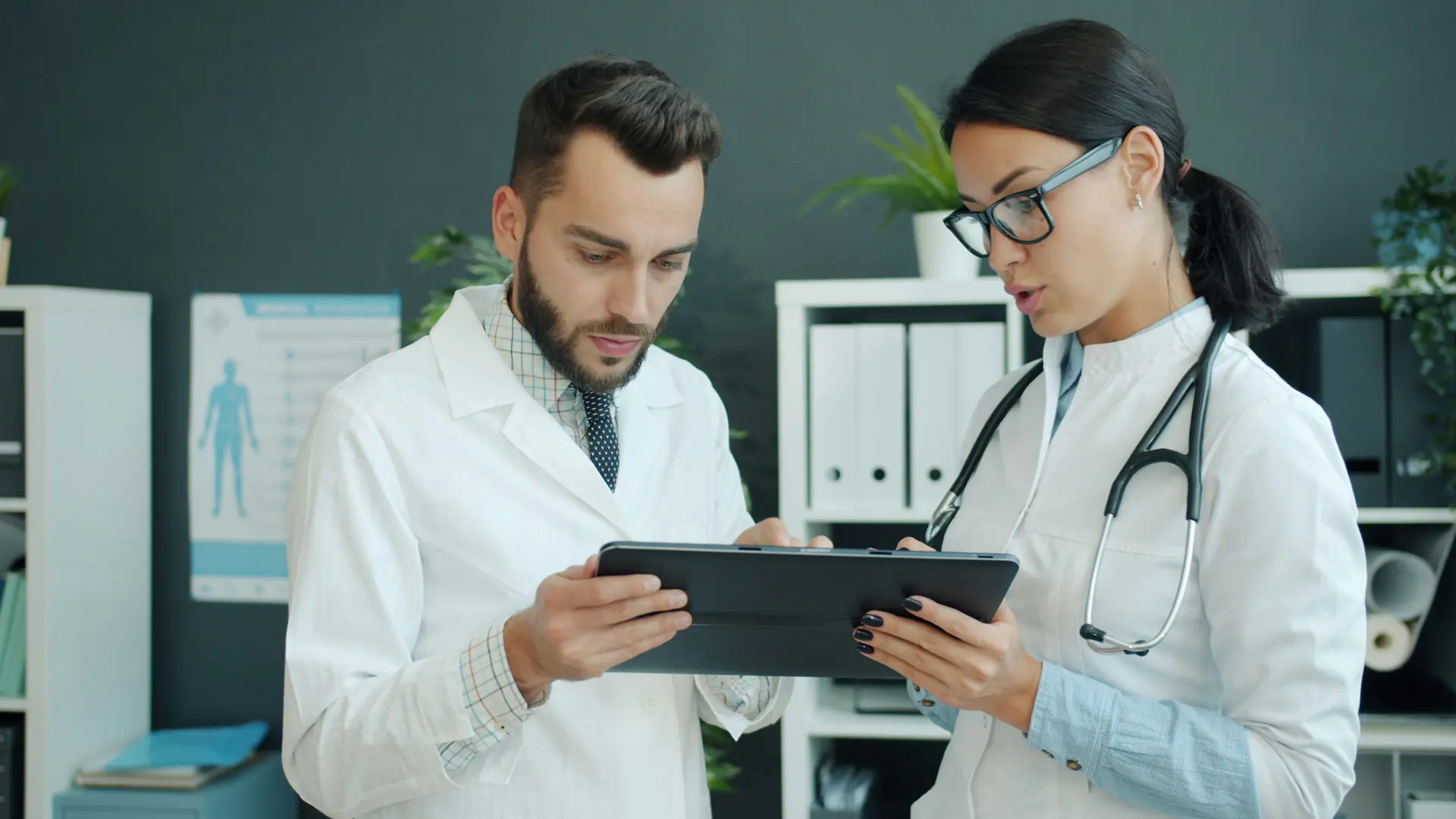 Two healthcare professionals reviewing a patient record together